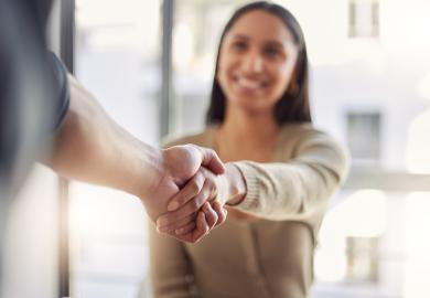 A woman and a man shaking hands