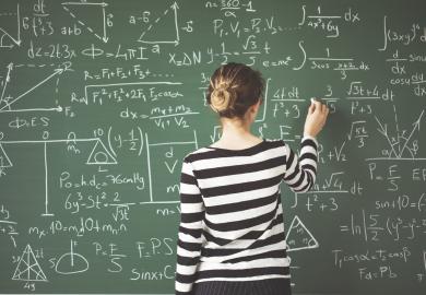 Student doing maths calculations on blackboard