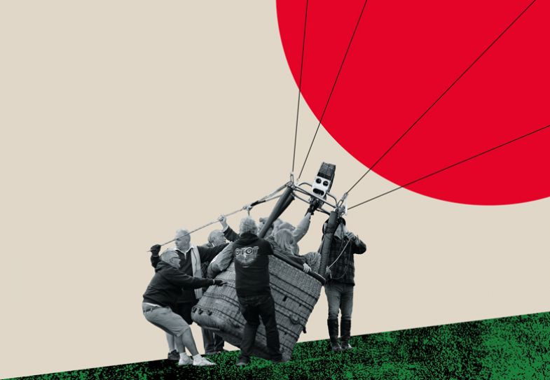 The basket of a hot air balloon tilts over as a balloon is inflated The basket of a hot air balloon tilts over as a balloon is inflated