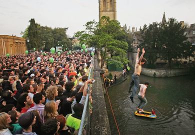 Oxford University students jump into the river from Magdalen Bridge